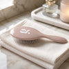 Glow Beauty Detangling Brush – front view showing stainless steel bristles and cushion base