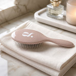 Glow Beauty Detangling Brush – front view showing stainless steel bristles and cushion base
